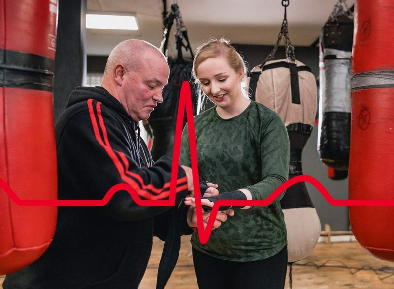 Resuscitation council brand image showing a young woman at boxing training with her instructor