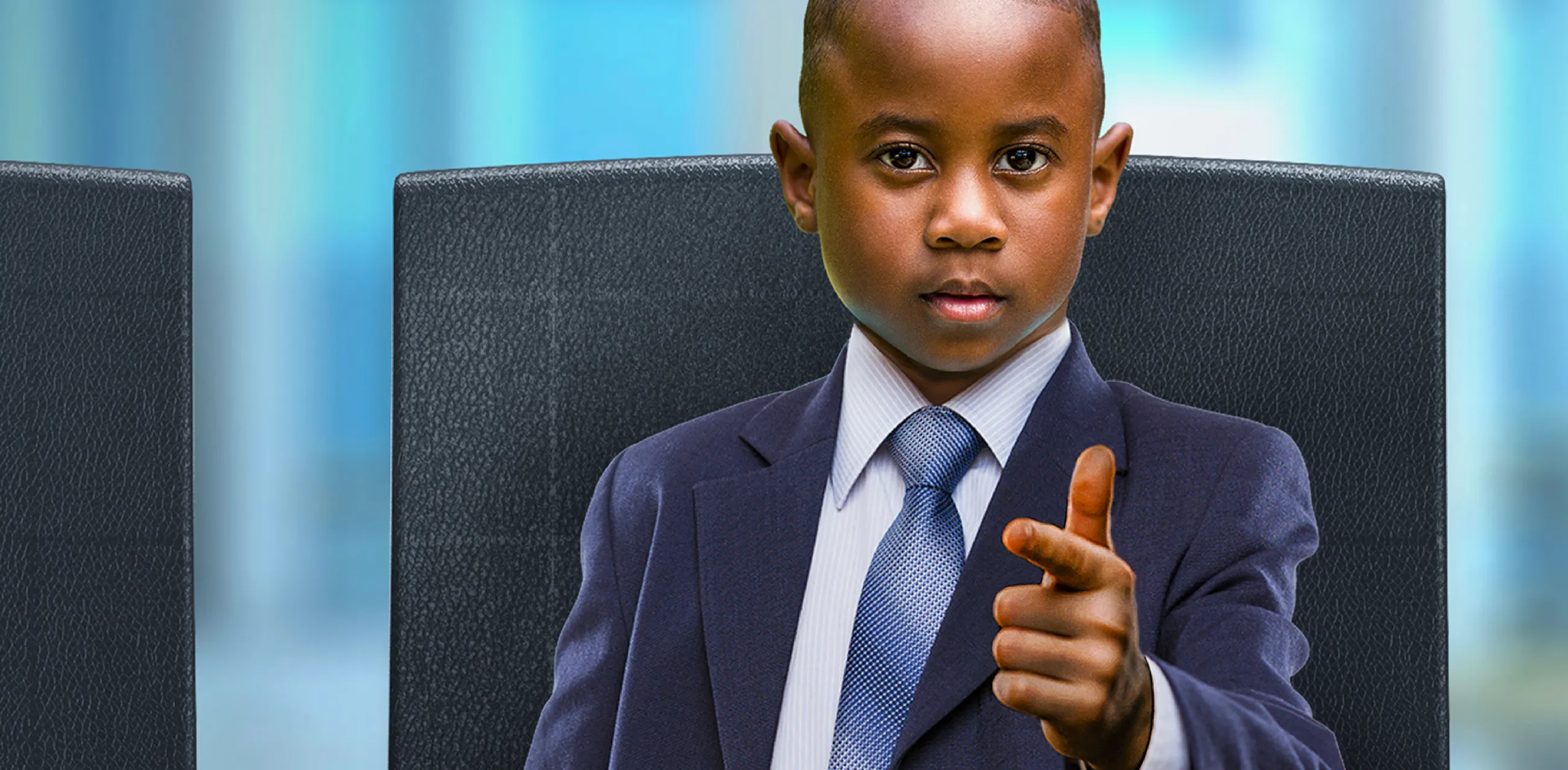 Teach First "Challenge the Impossible" campaign visuals showing a young boy dressed as an entrepreneur in a business suit, pointing at the viewer. 