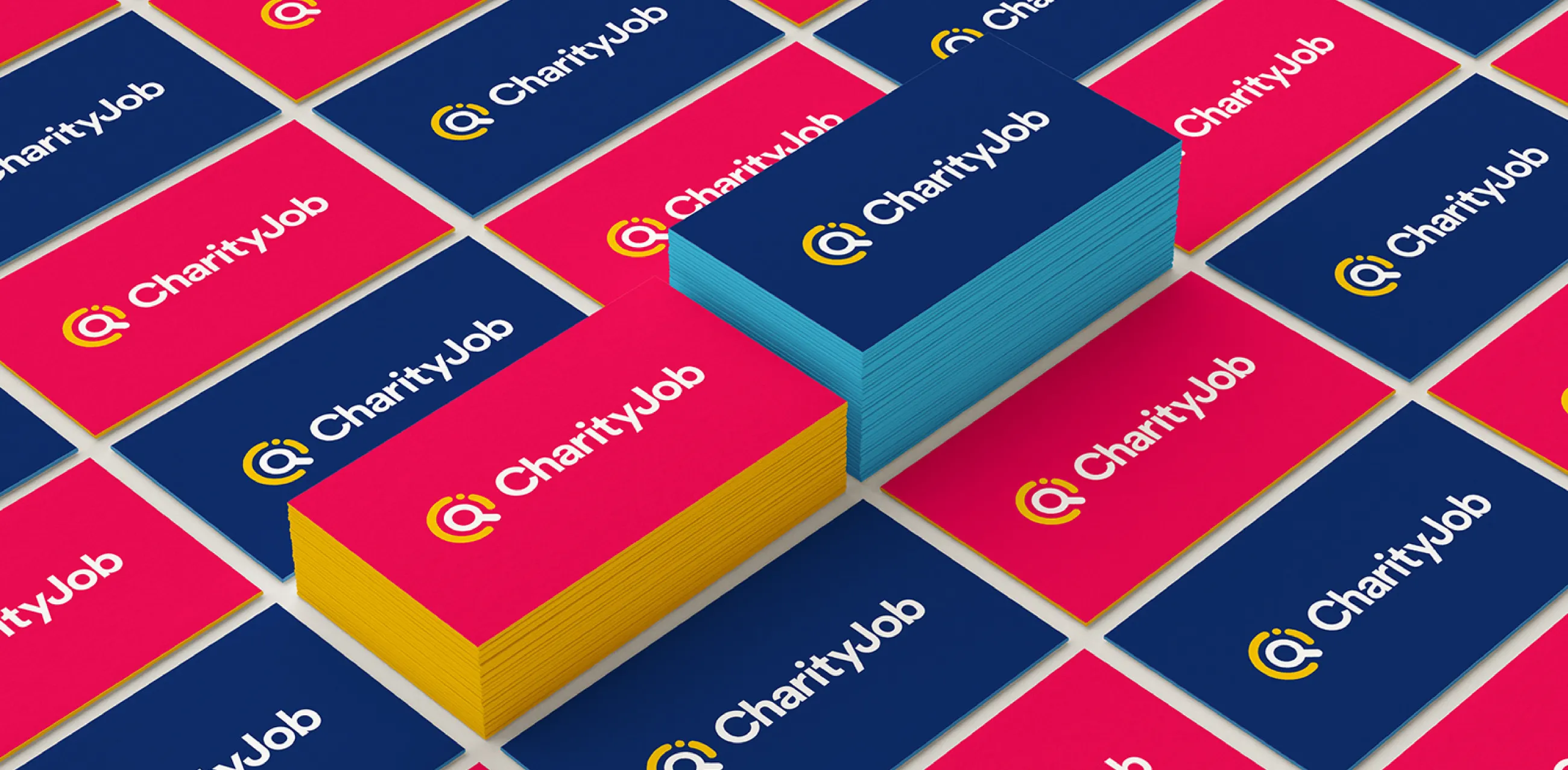 New CharityJob visual identity and logo shown on business cards