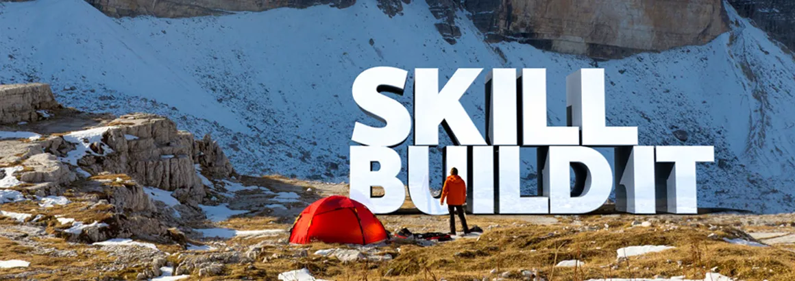 SKILL: BUILD IT - large 3D letters set in a mountain landscape, next to a red tent